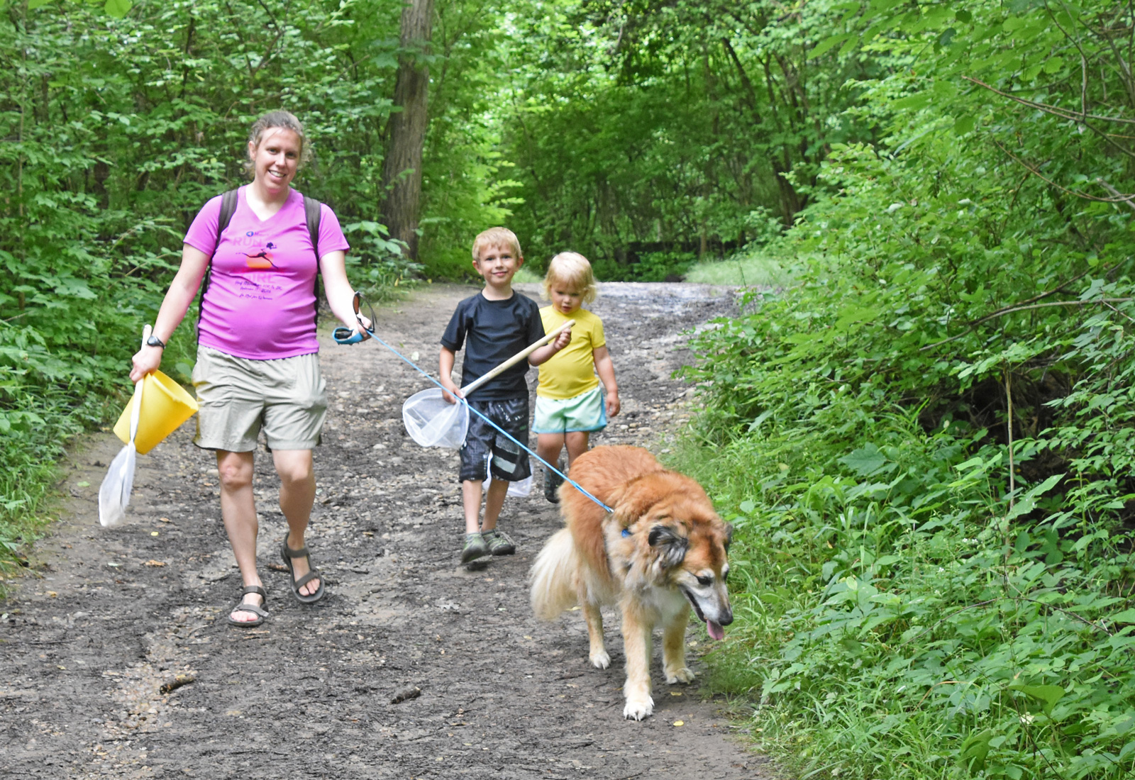 Mom, two kids and best furry friend on the Coyote Run Trail at Highbanks, heading to a creeking spot.